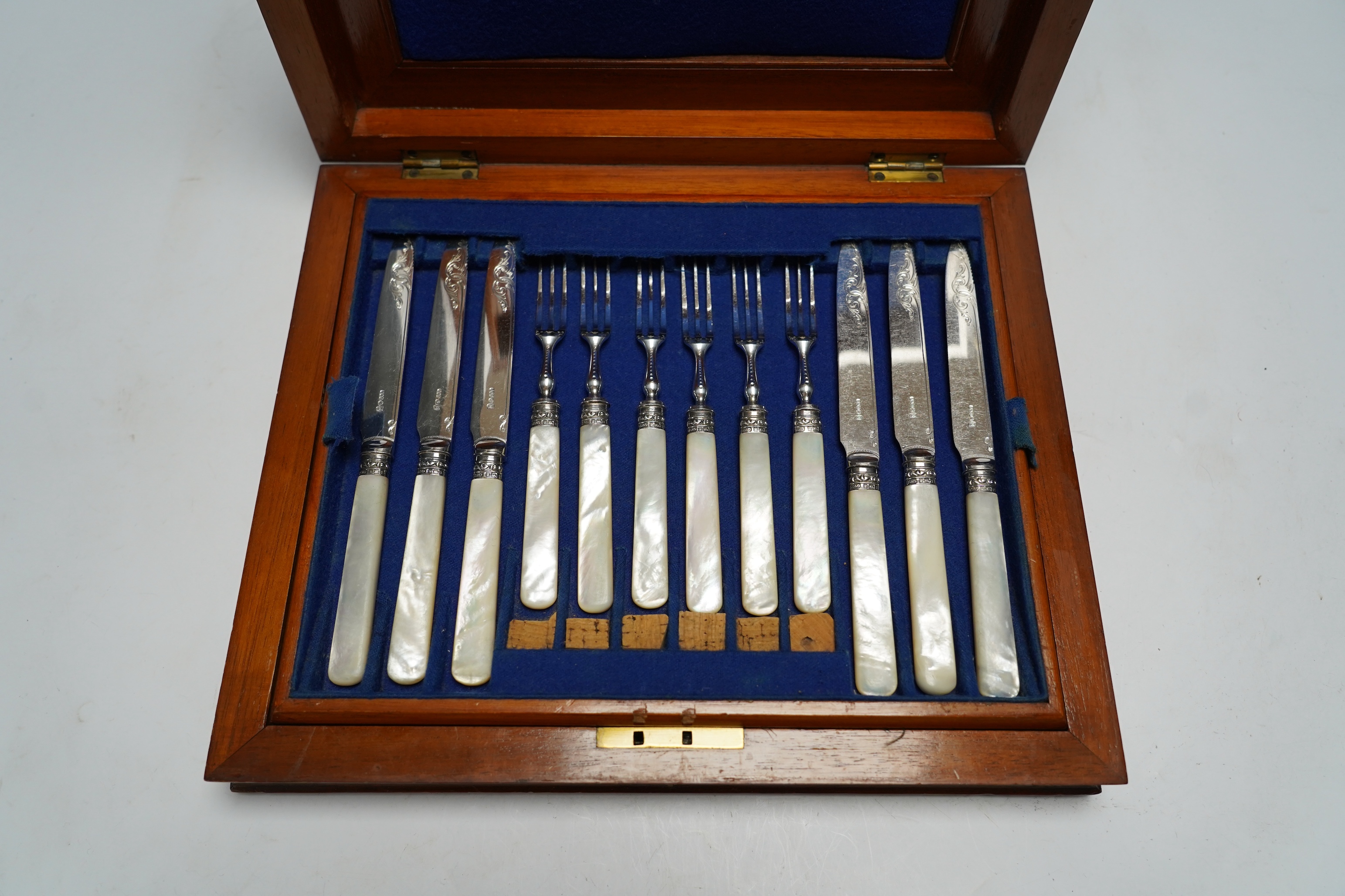 Two cased sets of silver plated dessert eaters, one with mother of pearl handles, largest 30cm wide, 27cm deep. Condition - cutlery good, largest case scratched